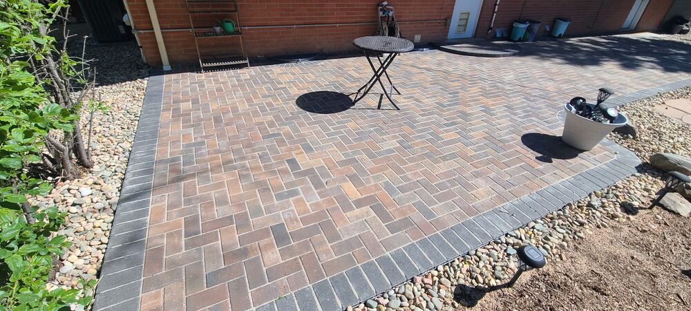 New paver patio with rock border
