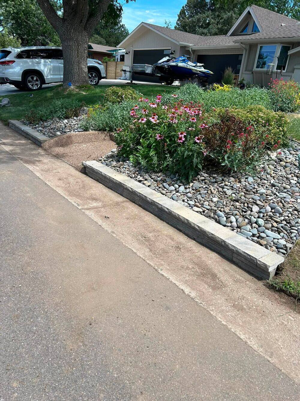 Stacked stone border with flower bed