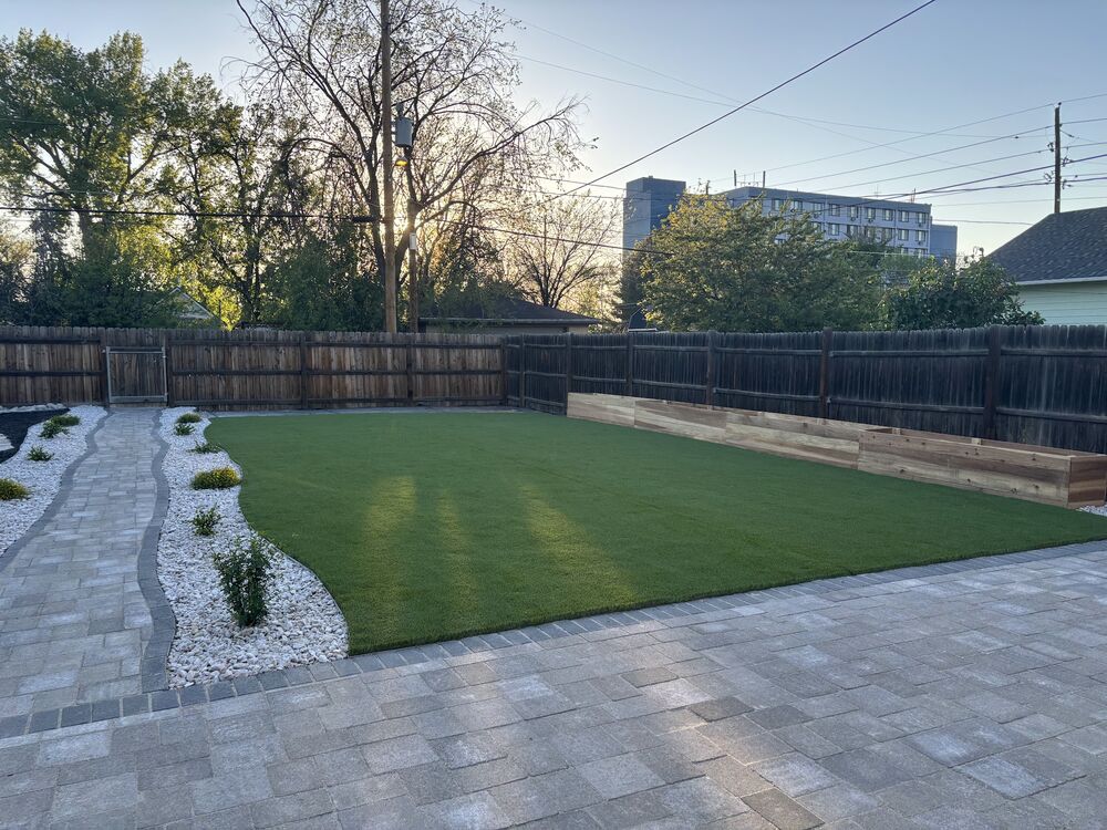 Backyard turf with white rock border at dusk