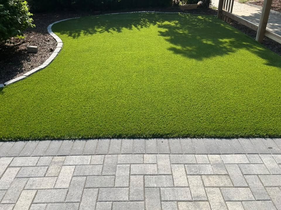 Backyard artificial turf with paver patio